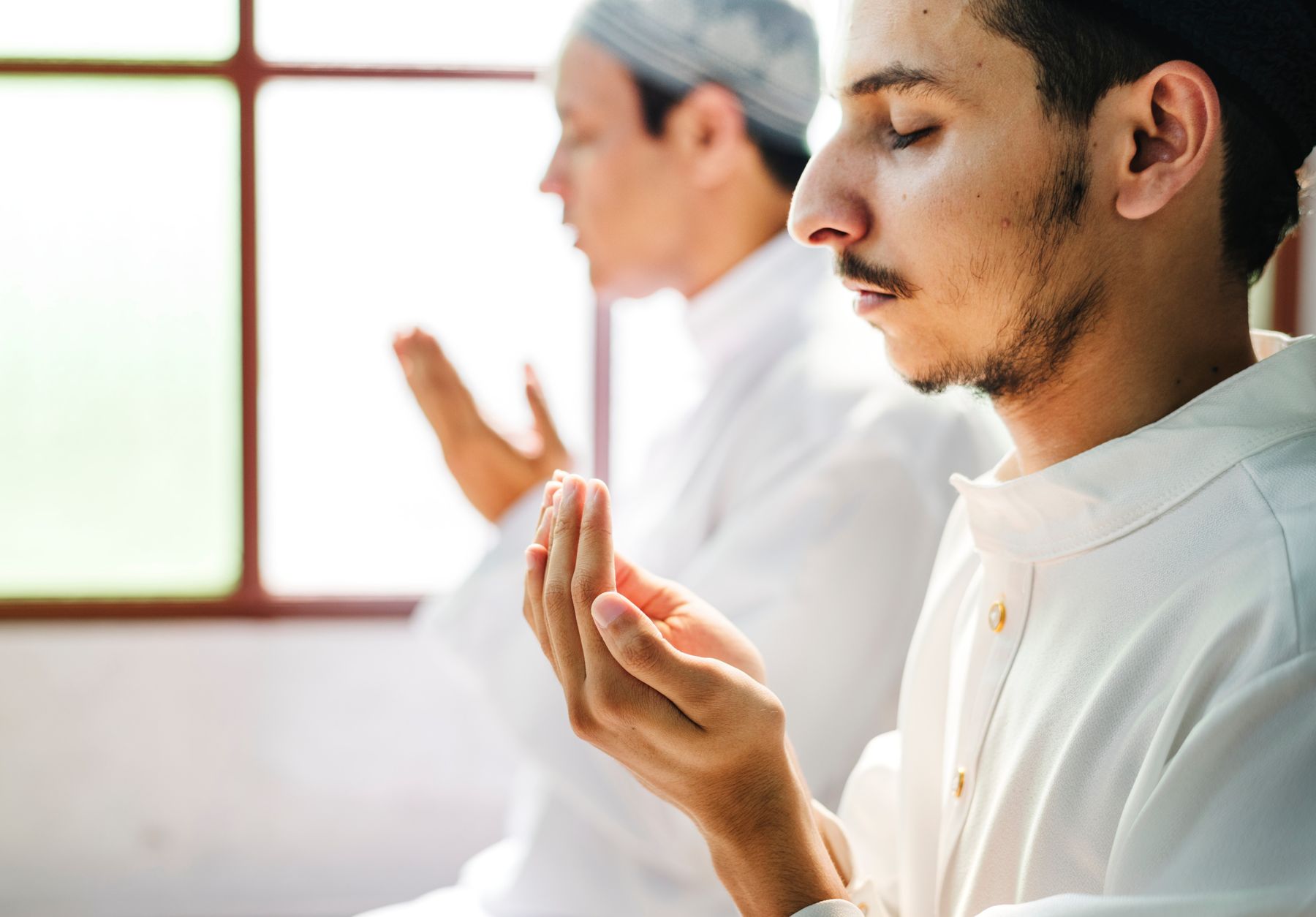 Two people in quiet prayer